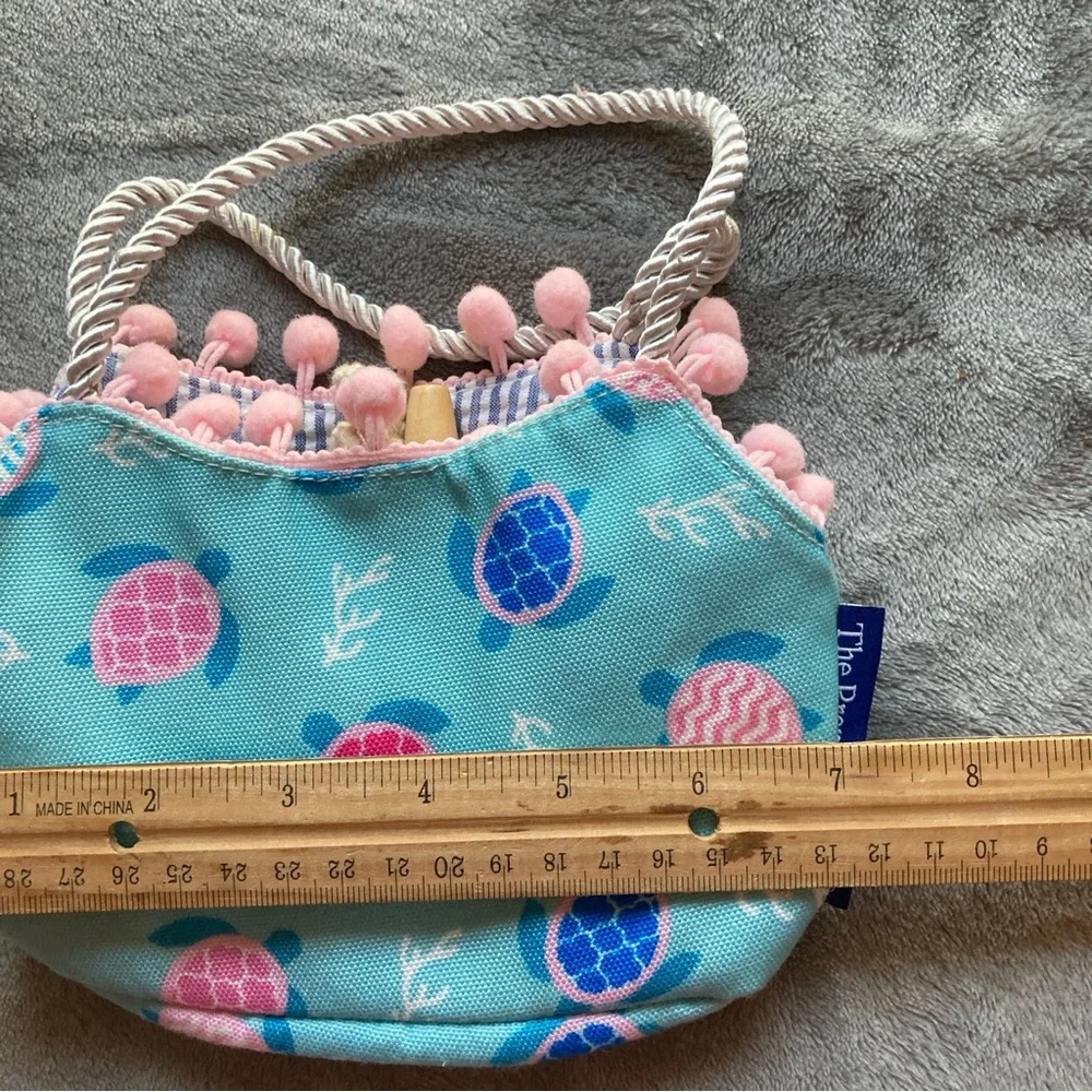 The Preppy Pelican Child's Bag by The Petting Zoo with Turtle Print & Pom Poms